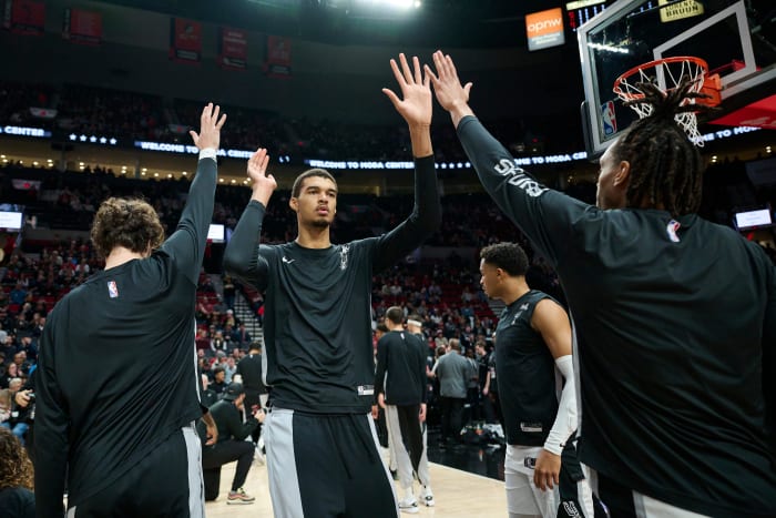 Dec 28, 2023; Portland, Oregon, USA; San Antonio Spurs center Victor Wembanyama (1) high-fives teammates during introductions before a game against the Portland Trail Blazers at Moda Center.